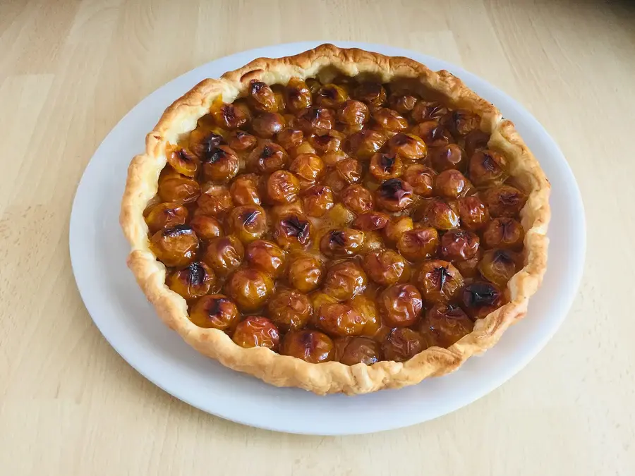 Tarte aux mirabelles servie sur une assiette, fruits rangés serrés